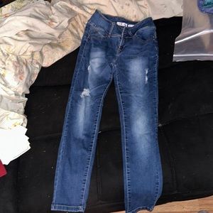Used dark blue ripped jeans.
